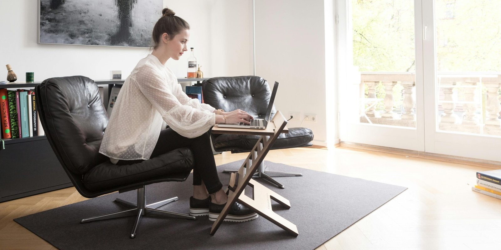 how to manage your home without stress
Woman working calmly on a laptop at home in a clean and organized living space